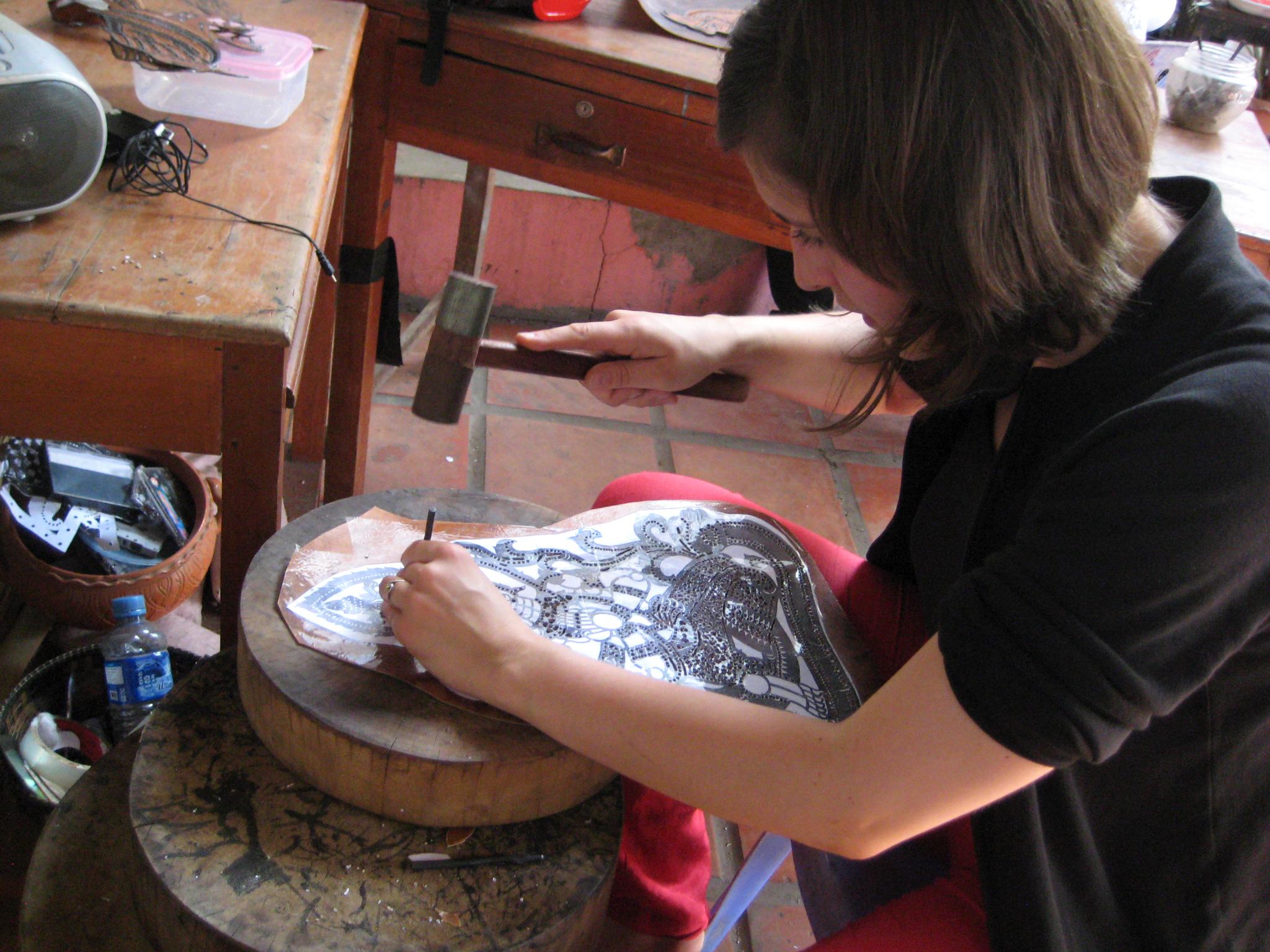 Female Projects Abroad Kymer Project Volunteer is leather carving to make puppets during her Cultural immersion project in Cambodia. Female Culture and Community Volunteer carves leather to create puppets in a centre during a Khmer cultural immersion project in Cambodia.